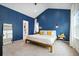 Charming main bedroom featuring navy blue wall paneling, bright natural light, and carpeted floor at 1702 W 66Th Ave, Denver, CO 80221