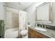 Updated bathroom featuring tiled shower, granite countertop, and a large mirror at 10462 Hoyt St, Westminster, CO 80021
