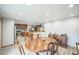Open dining area features a wooden table, light wood floors, and a view to the kitchen at 10462 Hoyt St, Westminster, CO 80021