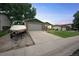 Single-Gathering home featuring a long driveway, two-car garage, boat, well-maintained lawn, and mature trees at 10462 Hoyt St, Westminster, CO 80021