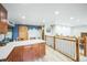 Modern kitchen island with seating area, custom cabinets, and bright interior lighting at 10462 Hoyt St, Westminster, CO 80021