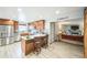 Updated kitchen features stainless steel appliances, an island with seating, and stylish countertops at 10462 Hoyt St, Westminster, CO 80021