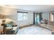 Cozy living room with comfortable seating, large windows, and sliding glass doors to the backyard at 10462 Hoyt St, Westminster, CO 80021