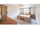 Spacious main bedroom with a ceiling fan, large window, and soft neutral carpet at 10462 Hoyt St, Westminster, CO 80021