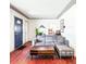 Inviting living room with hardwood floors, a comfortable grey sectional, and updated trim at 2701 S Hazel Ct, Denver, CO 80236