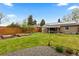 Lush backyard with green lawn, patio, and garden, ideal for outdoor enjoyment and relaxation at 760 Niagara St, Denver, CO 80220