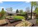 Expansive backyard featuring raised garden beds, green lawn, and patio, providing a serene outdoor oasis at 760 Niagara St, Denver, CO 80220