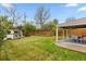 Spacious backyard with lush lawn, covered patio, shed, and garden beds, perfect for outdoor living and entertaining at 760 Niagara St, Denver, CO 80220