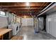 Unfinished basement with exposed beams, washer, dryer, and plenty of storage space at 760 Niagara St, Denver, CO 80220