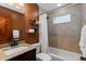 Bathroom with tile shower, glass block window, and vanity with granite countertop at 760 Niagara St, Denver, CO 80220