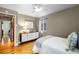 Comfortable bedroom with a ceiling fan, hardwood floors, and modern dresser at 760 Niagara St, Denver, CO 80220