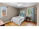 Cozy bedroom featuring natural light, a ceiling fan, and hardwood floors at 760 Niagara St, Denver, CO 80220