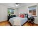 Inviting bedroom featuring hardwood floors, two windows, and stylish decor at 760 Niagara St, Denver, CO 80220