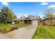 Charming single-story home featuring a well-manicured lawn and a cozy front porch and driveway at 760 Niagara St, Denver, CO 80220