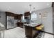 Modern kitchen with stainless steel appliances, granite countertops, and a breakfast bar seating area at 760 Niagara St, Denver, CO 80220