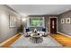 Elegant living room with hardwood floors, and large window offering natural light and backyard views at 760 Niagara St, Denver, CO 80220