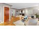 Open-concept living room with hardwood floors, stylish decor, and seamless flow to the kitchen at 760 Niagara St, Denver, CO 80220
