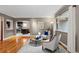 Bright living room featuring hardwood floors, modern furniture, and a view into the kitchen area at 760 Niagara St, Denver, CO 80220