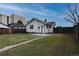 Backyard featuring a grassy lawn, privacy fence, and concrete patio outside of the home's back entrance at 5185 Alcott St, Denver, CO 80221