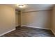 Bedroom with wood-look floors, neutral walls, a window, and a closet with a hanging rack at 5185 Alcott St, Denver, CO 80221