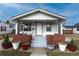 Inviting front porch with seating, brick accents, and a well-maintained entrance, perfect for relaxing outdoors at 5185 Alcott St, Denver, CO 80221