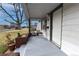 Charming covered porch with chairs, ideal for enjoying the neighborhood view at 5185 Alcott St, Denver, CO 80221