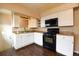 Efficient kitchen with white cabinets, black appliances, and ample countertop space at 5185 Alcott St, Denver, CO 80221