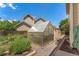 Backyard showcasing a greenhouse surrounded by lush greenery and garden beds at 3494 S Otis Ct, Lakewood, CO 80227