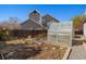 View of a spacious backyard with a greenhouse and garden, perfect for outdoor enjoyment at 3494 S Otis Ct, Lakewood, CO 80227