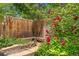 Backyard oasis featuring a wooden fence, rose bushes, and a wooden bench at 3494 S Otis Ct, Lakewood, CO 80227