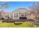 A generous sized backyard with a covered patio, flower beds and ample lawn at 3494 S Otis Ct, Lakewood, CO 80227