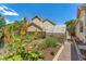 Spacious backyard with a greenhouse, garden beds, and a privacy fence at 3494 S Otis Ct, Lakewood, CO 80227