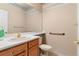 Convenient half bathroom with a vanity, mirror, and toilet at 3494 S Otis Ct, Lakewood, CO 80227
