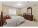 Comfortable bedroom with floral wallpaper, a large window, and classic furnishings, creating a cozy retreat at 3494 S Otis Ct, Lakewood, CO 80227