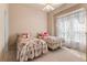 Bedroom with floral bedspreads and large window with lace curtains at 3494 S Otis Ct, Lakewood, CO 80227