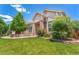 Lovely exterior of home with beautiful landscaping and manicured lawn at 3494 S Otis Ct, Lakewood, CO 80227