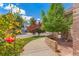 Charming home with beautiful landscaping, a brick walkway, and colorful flowers at 3494 S Otis Ct, Lakewood, CO 80227