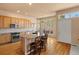 Bright kitchen with hardwood floors, center island, and stainless steel appliances at 3494 S Otis Ct, Lakewood, CO 80227