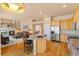 Bright, open kitchen with granite countertops, stainless steel appliances, hardwood floors, and seamless flow to living room at 3494 S Otis Ct, Lakewood, CO 80227