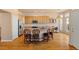 Kitchen with island seating, stainless appliances, and wood floors at 3494 S Otis Ct, Lakewood, CO 80227