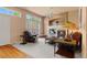 Inviting living room with plush seating, fireplace, and bright natural light at 3494 S Otis Ct, Lakewood, CO 80227