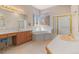 Luxurious main bathroom featuring dual vanities, a soaking tub, and a separate shower, offering a spa-like experience at 3494 S Otis Ct, Lakewood, CO 80227