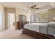 Main bedroom with a large window, ceiling fan, and dresser at 3494 S Otis Ct, Lakewood, CO 80227