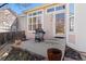 Patio area with a grill, door to the home, and steps at 3494 S Otis Ct, Lakewood, CO 80227