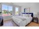 Well-lit bedroom featuring a large window, a comfortable bed, and stylish accents at 5142 W 44Th Ave, Denver, CO 80212
