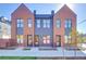 Charming brick townhomes with eye-catching windows, front stoops, and modern design at 5142 W 44Th Ave, Denver, CO 80212