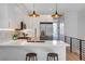 Modern kitchen boasting sleek white cabinets, quartz counters, and stainless steel appliances at 5142 W 44Th Ave, Denver, CO 80212