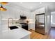 Modern kitchen with white cabinets, stainless steel appliances, and quartz countertops at 5142 W 44Th Ave, Denver, CO 80212