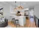 Contemporary kitchen with stainless steel appliances, sleek white cabinetry, and a stylish breakfast bar at 5142 W 44Th Ave, Denver, CO 80212