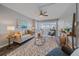 Inviting living room featuring a plush sofa, area rug, and a ceiling fan with view into sunroom at 800 N Washington St # 706, Denver, CO 80203